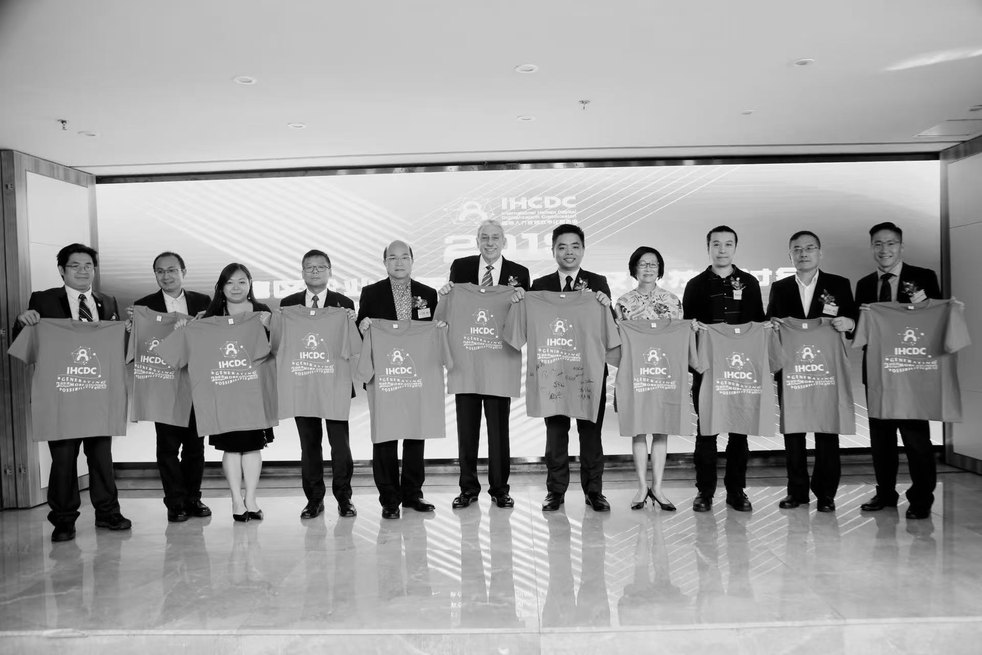 Council Members and guests with the IHCDC shirts at the close of the inauguration ceremony; Danny Chan holds the shirt s